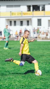 Person striking soccer ball