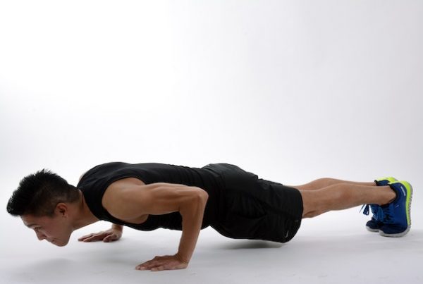 Man doing push ups for golf at home workout