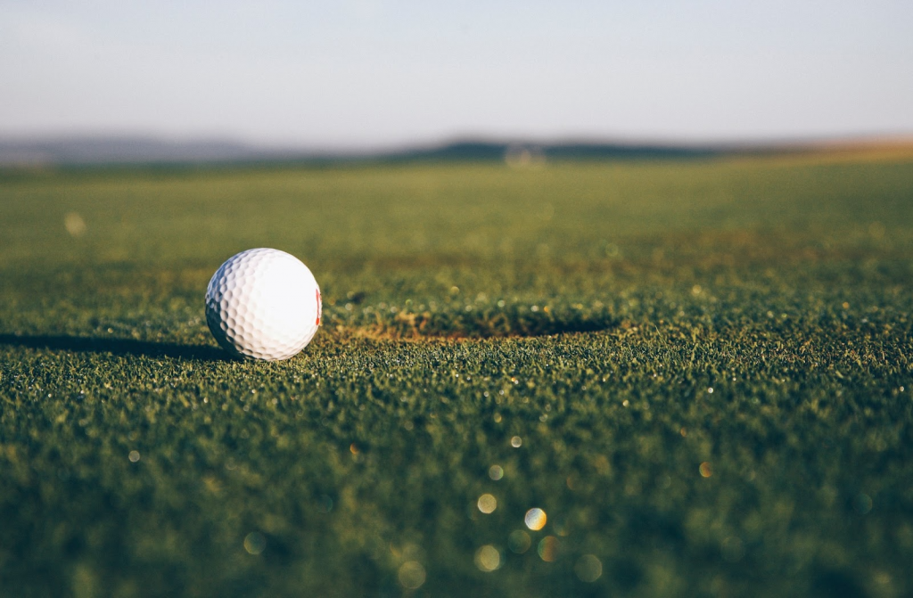 golf ball going into hole