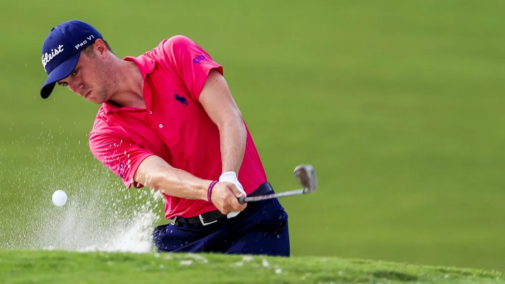 golfer hitting ball out of bunker