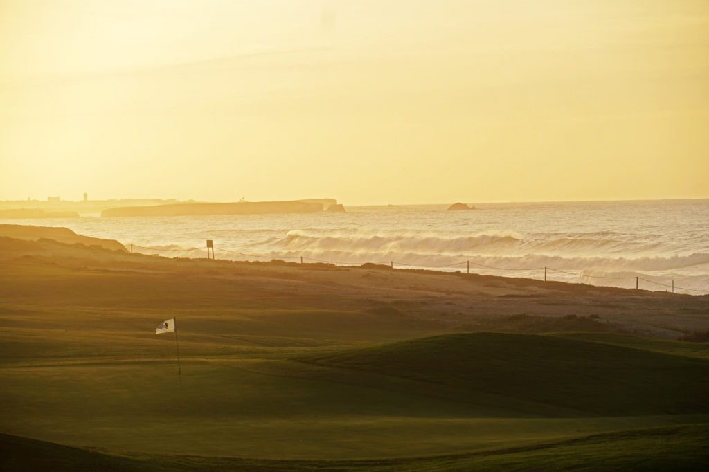 beautiful golf course by beach at sunset